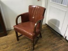 A 1930s walnut framed leather upholstered tub easy chair with scrolling arms, raised on square