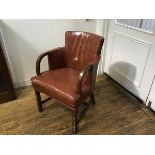 A 1930s walnut framed leather upholstered tub easy chair with scrolling arms, raised on square