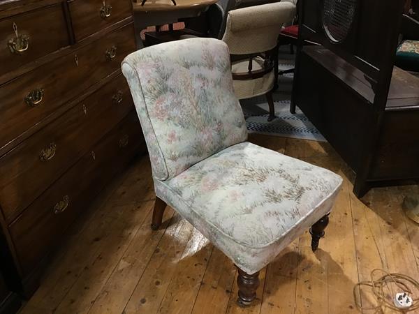 A Victorian walnut framed nursing chair with upholstered panel back and seat, in tapestry machine