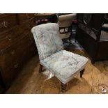 A Victorian walnut framed nursing chair with upholstered panel back and seat, in tapestry machine
