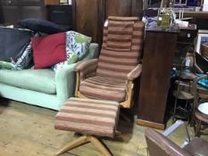 An Ercol ash recliner easy chair with upholstered back, arms and seat, in striped velour fabric,
