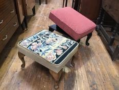 A walnut upholstered footstool with tapestry top, raised on carved moulded supports and pad feet and