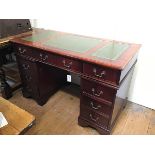 A mahogany reproduction twin pedestal kneehole desk, the top with inset green skiver and moulded