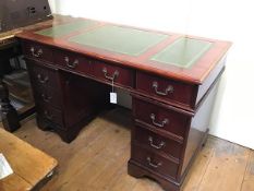 A mahogany reproduction twin pedestal kneehole desk, the top with inset green skiver and moulded