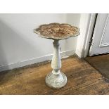 A cast iron painted bird bath with scalloped shaped dish to top on baluster column and fluted