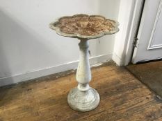 A cast iron painted bird bath with scalloped shaped dish to top on baluster column and fluted