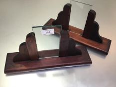 A pair of Art Deco treen photograph frames with shaped uprights and rectangular bases (one lacking