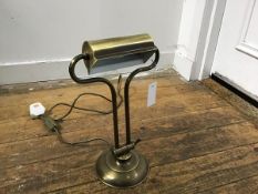 A brass brushed finish adjustable modern desk lamp on circular moulded base (h.36cm fully upright.