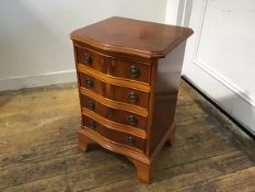 A yew wood miniature serpentine chest, the top with moulded edge above four long drawers, on bracket