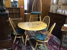 An Ercol light ash five piece kitchen/dining set comprising hoop back and spar back chairs and