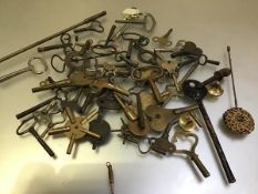 A collection of various clock keys including carriage clocks, mantel clocks, longcase clocks,