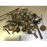 A collection of various clock keys including carriage clocks, mantel clocks, longcase clocks,