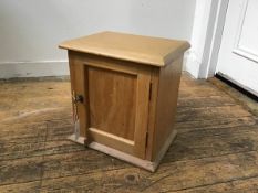 A 19thc pine cupboard, the top with moulded edge and inset panel door, on plinth base (h.34cm x 34cm