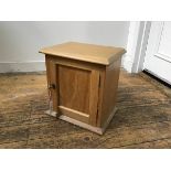 A 19thc pine cupboard, the top with moulded edge and inset panel door, on plinth base (h.34cm x 34cm