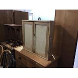 A 19thc shaped sided pine and plywood two door wall cabinet (h.68cm x 70cm x 23cm)