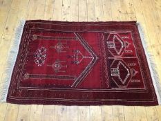 A Turkoman style prayer rug, with pointed arch and three hanging lanterns, flanked by columns,