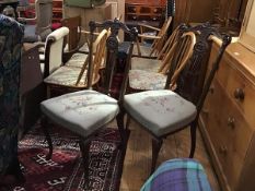 A pair of Edwardian mahogany pierced and carved spar back side chairs with stuffover seats, in