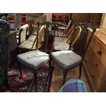 A pair of Edwardian mahogany pierced and carved spar back side chairs with stuffover seats, in