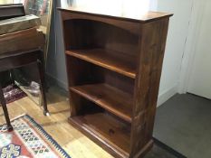 A stained pine upright open bookcase, fitted two adjustable shelves (h.106cm x 75cm x 30cm)