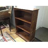 A stained pine upright open bookcase, fitted two adjustable shelves (h.106cm x 75cm x 30cm)