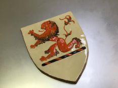 A Clarice Cliff Newport Pottery shield depicting a Rampant Lion (28cm x 23cm)