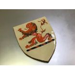 A Clarice Cliff Newport Pottery shield depicting a Rampant Lion (28cm x 23cm)