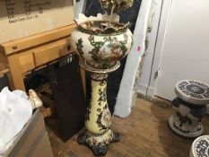 A Victorian jardiniere on associated stand with painted vingnettes, raised on scroll feet (