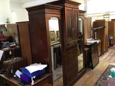 An Edwardian mahogany breakfront wardrobe, the cornice with satinwood crossbanded border fitted a