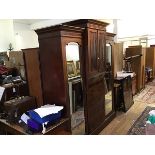 An Edwardian mahogany breakfront wardrobe, the cornice with satinwood crossbanded border fitted a