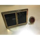 An oval rope pattern bordered miniature photograph frame on easel stand, stamped 925 indistinctly (