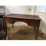 An Edwardian oak writing table,the rectangular top with inset skiver and centre frieze drawer,