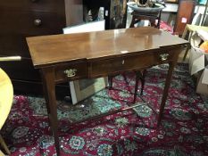 A 19thc mahogany breakfront side table, with crossbanded top, fitted centre frieze drawer, flanked