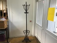 A cast iron centre column hat and coat stand with scroll ends on splay supports, complete with