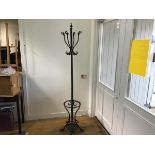 A cast iron centre column hat and coat stand with scroll ends on splay supports, complete with