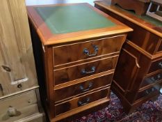 A yew wood leather topped two drawer filing cabinet with brass handles to front on plinth base (h.