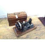 A late 19thc/early 20thc hand sewing machine with walnut inlaid case, with handle to top (catch does