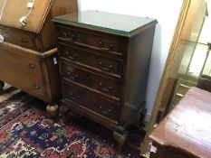 A mahogany chest, the rectangular top above four graduated long drawers, raised on shell carved