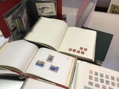 A box containing nine various albums, stamps and postcards: British, Churchill, Austria, British