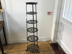 A reproduction cast iron six graduated tier pot stand, raised on tripod support (h.123cm x d. to