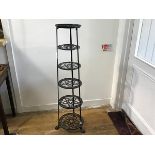 A reproduction cast iron six graduated tier pot stand, raised on tripod support (h.123cm x d. to