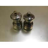 A pair of London silver pepperettes by Frank Green (one a/f) (h.6cm)