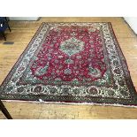 A Tabriz rug, the centre medallion enclosed within spiralling lotus flower and leaf border, and