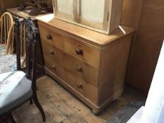 A Victorian stripped pine chest, the rectangular top with rounded angles above two short and two