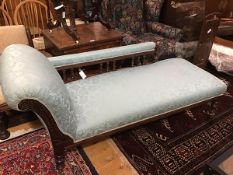 An Edwardian oak chaise longue, the upholstered rail back and scroll and seat, in teal damask