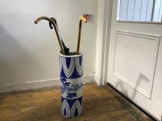 A modern Chinese porcelain cylinder stick stand with stylised landscape panel, including walking