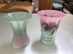 Two cased glass pink to green and green to pink swirling tapered vases, one with ribbed base,