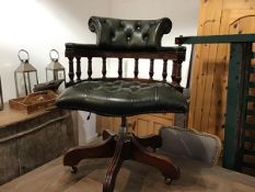 A mahogany framed business style captains chair with green leather button back, arms and seat,