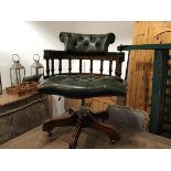 A mahogany framed business style captains chair with green leather button back, arms and seat,