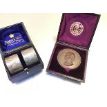 A pair of Mappin & Webb engraved napkin rings and a bronze Richard Cobden, 1804-1865 presentation