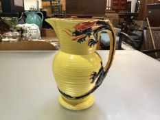 A Burleigh ware pottery ribbed 1930s style jug with four claw dragon handle, yellow ground (h.25cm x